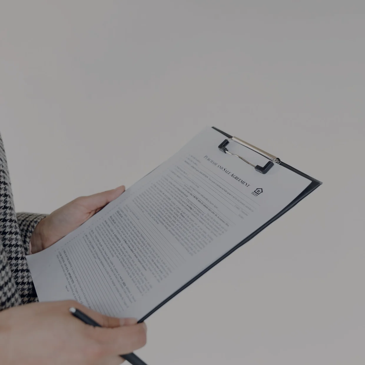 Reviewing a document on a clipboard.