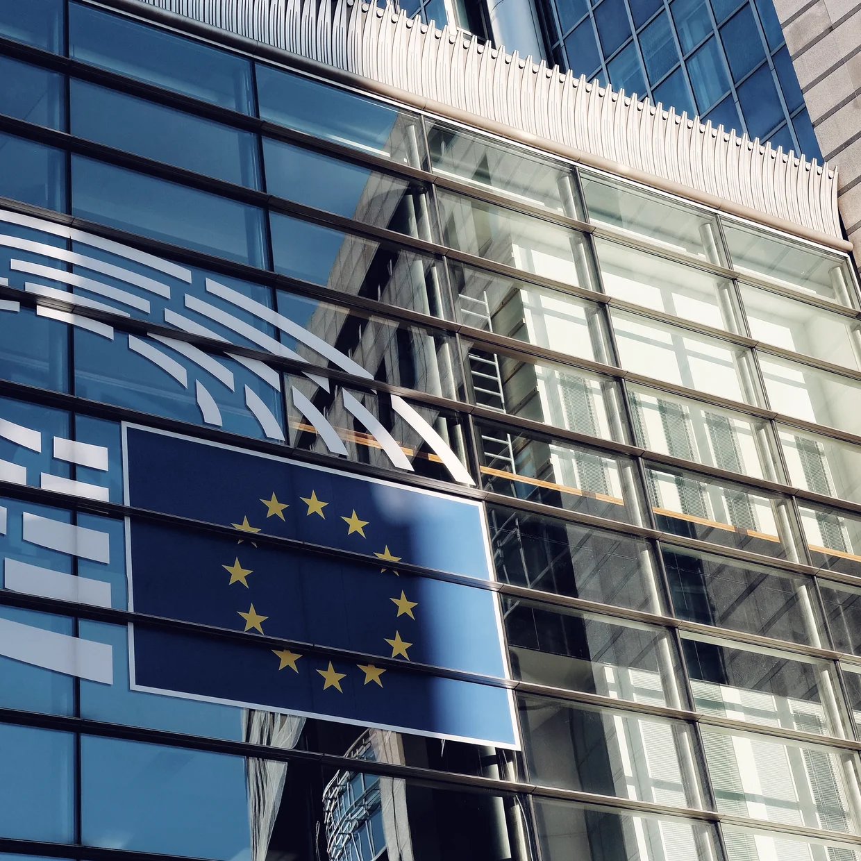 The EU flag set into a glass building front.